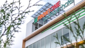 A hotel with a modern design, featuring a large cactus mural on the facade. - Three Eight Front One Boutique Batu (Batu)