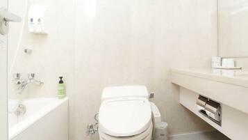 A modern bathroom with a white toilet, a sink, and a mirror.