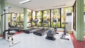 A gym with treadmills, elliptical machines, and a stationary bike. - Forbeswood Heights near St Lukes (Taguig)