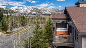 A wooden cabin with a hot tub, surrounded by snow-covered mountains and pine trees. - Private Hot tub & BBQ, Shuttle! Luxury Amenities & walk to lifts (Park City)