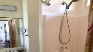 A bathroom with a bathtub, a toilet, a sink, and a mirror.