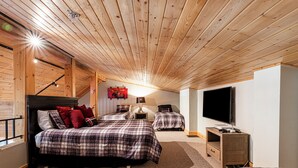 A cozy bedroom with two beds, a TV, and a desk. - Private Hot tub & BBQ, Shuttle! Luxury Amenities & walk to lifts (Deer Valley)