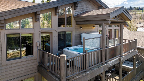 A multi-story house with a hot tub on the second floor balcony. - Private Hot tub & BBQ, Shuttle! Luxury Amenities & walk to lifts (Deer Valley)