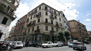 A multi-story building with a ground-floor shop and upper-floor apartments.