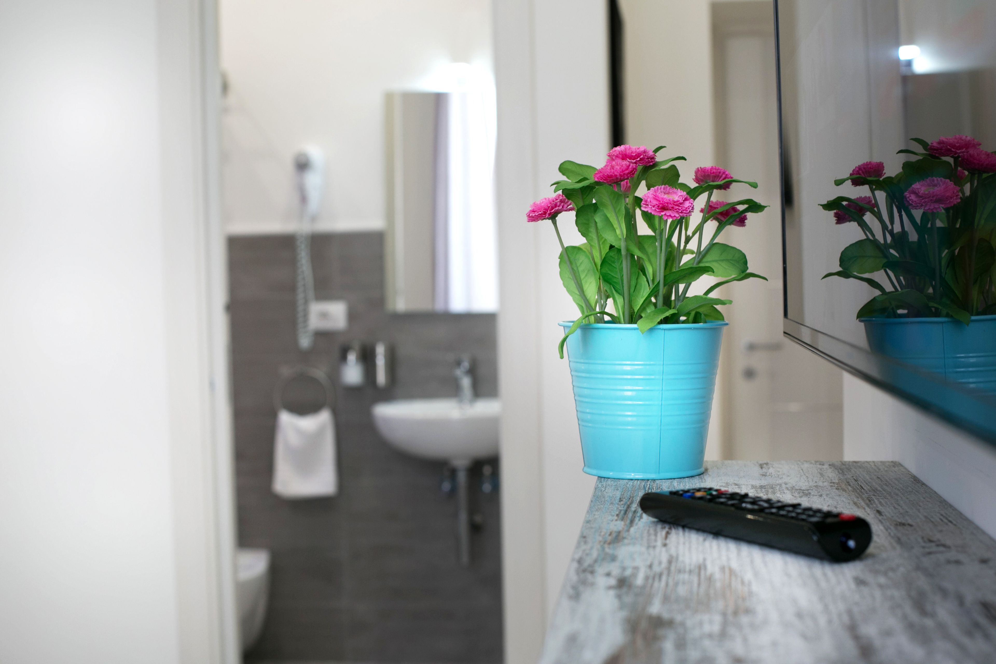 A bathroom with a sink, mirror, and towel rack.