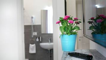 A bathroom with a sink, mirror, and towel rack.