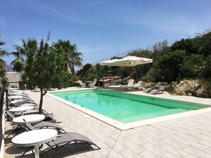 Piscine extérieure, parasols de plage, chaises longues