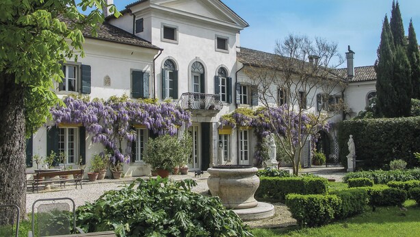 A large, historic building with a symmetrical facade, multiple windows, and a central entrance. - Villa di Tissano (Santa Maria la Longa)