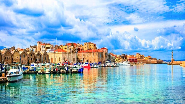 A harbor with boats, historic buildings, and a prominent tower. - Perla Villas with Heated Pool (Apokoronas)