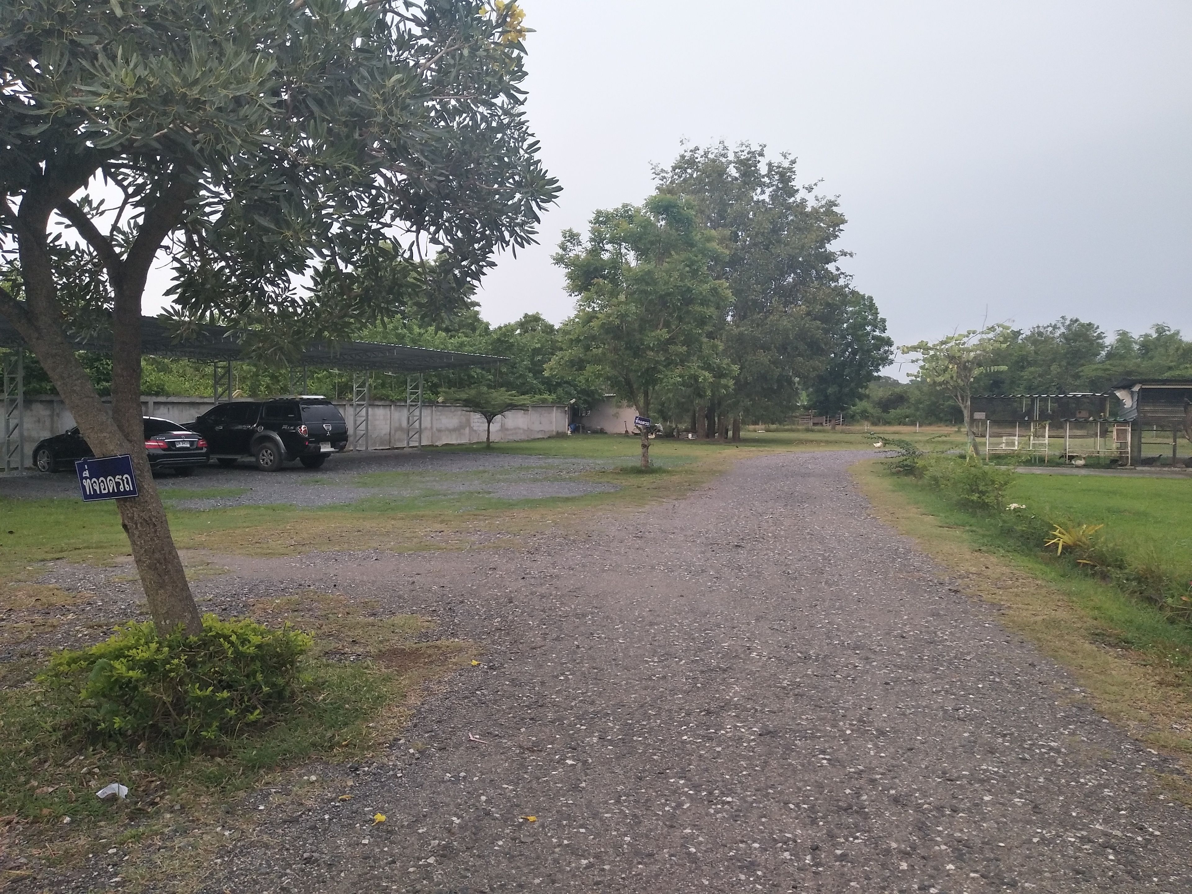 Un sendero de grava que lleva a un edificio con un porche cubierto.