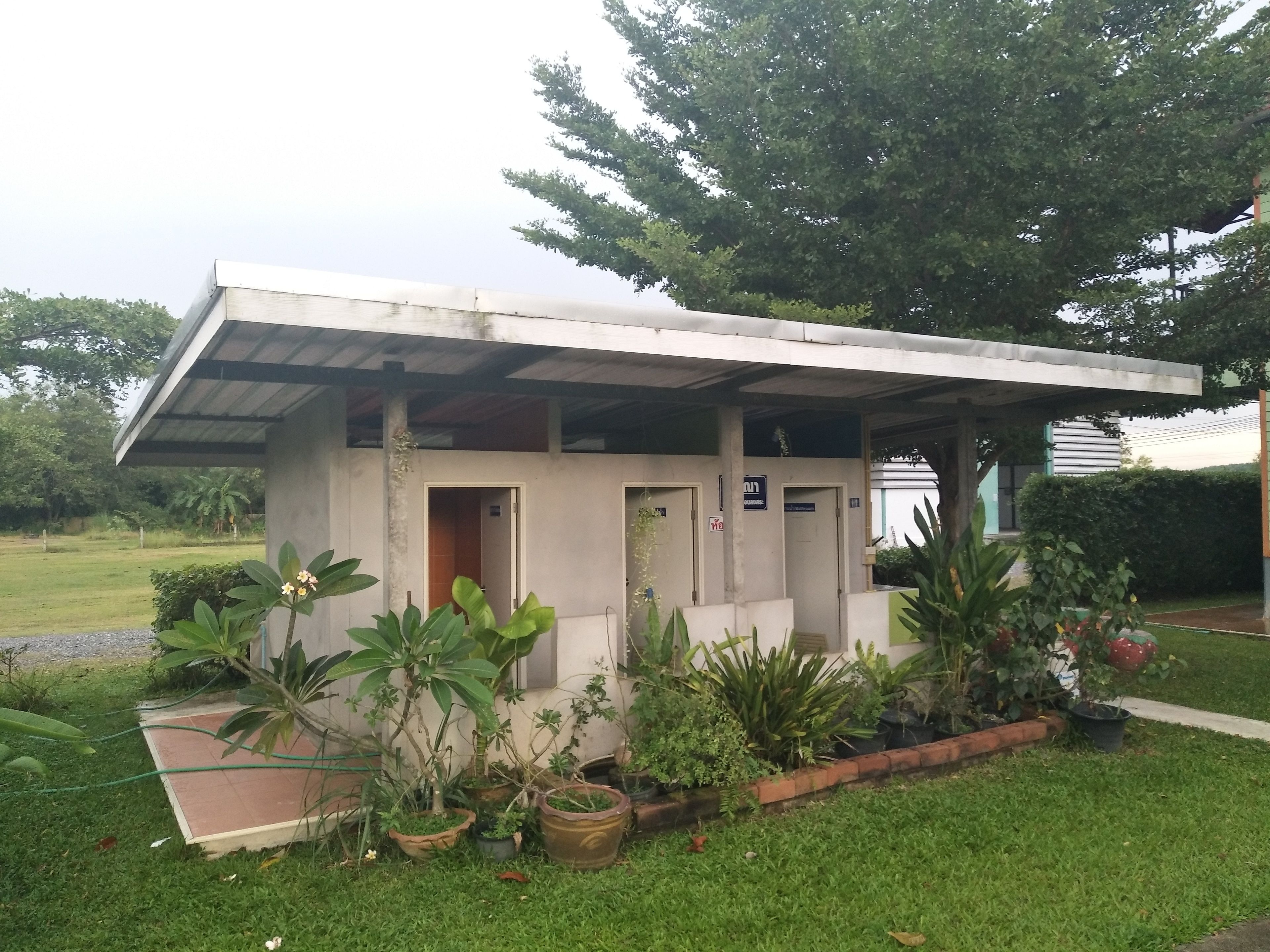 A small, single-story building with a covered porch, a door, and a window.