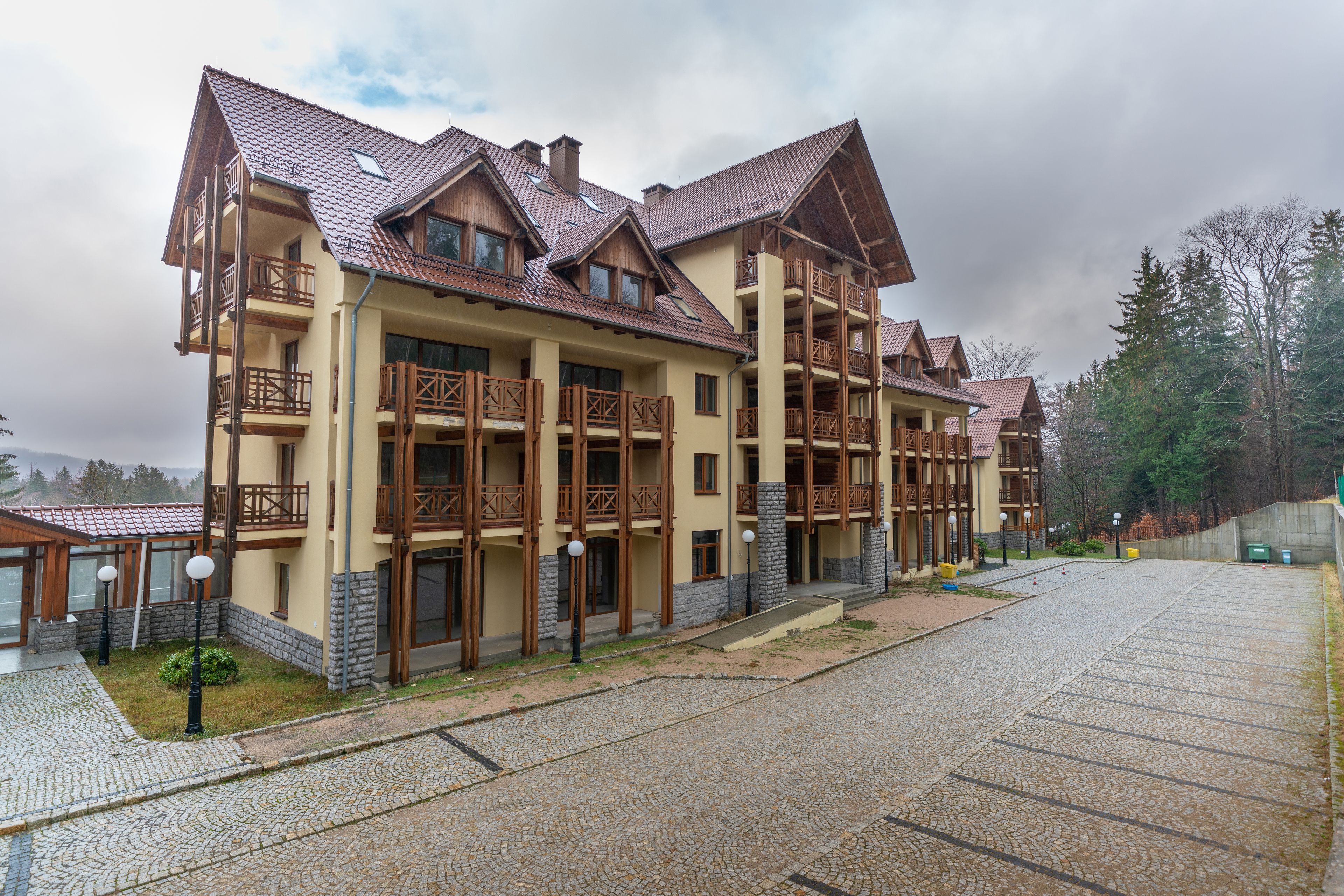 A multi-story hotel with balconies and a stone facade.