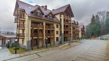 A multi-story hotel with balconies and a stone facade.
