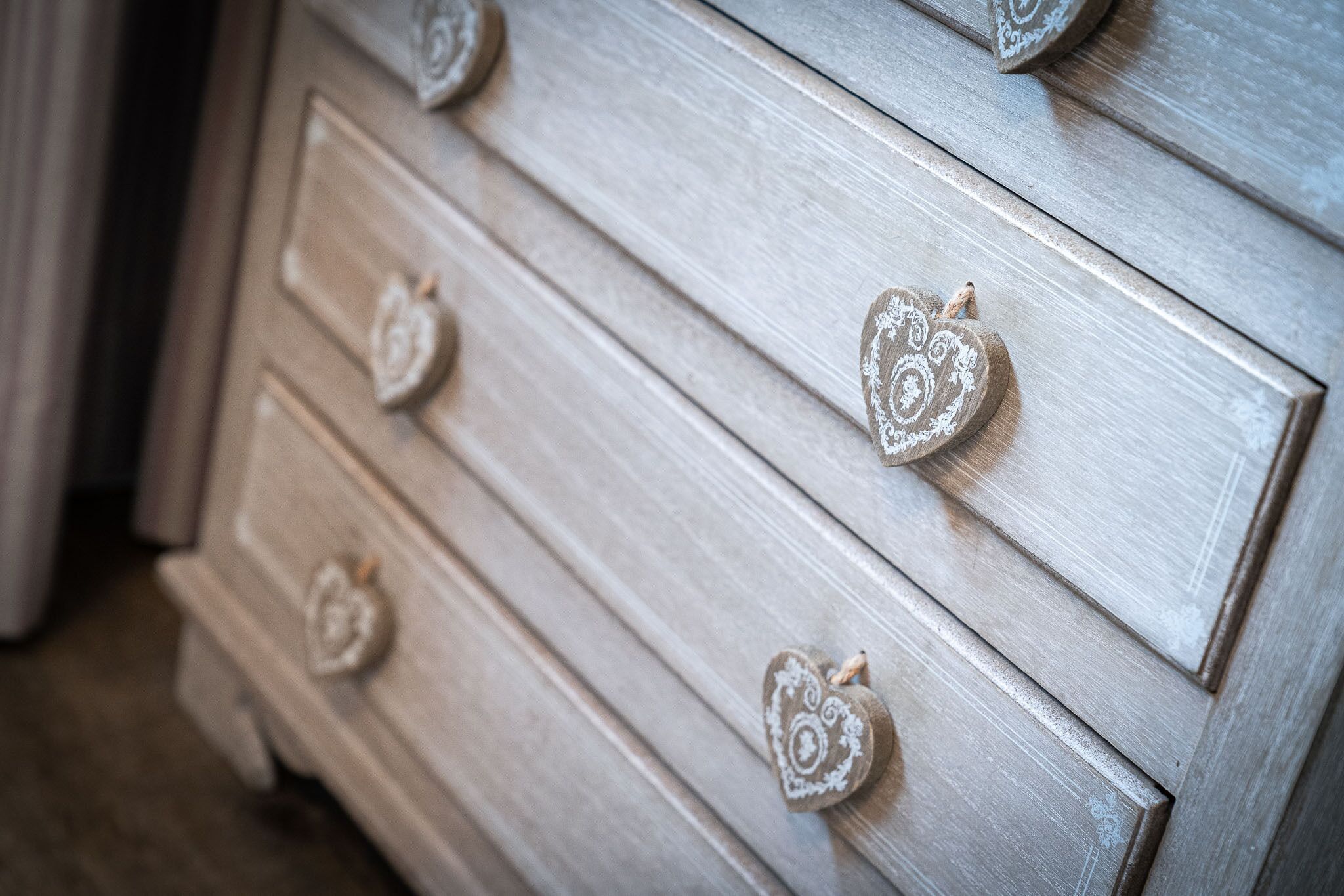 A wooden dresser with heart-shaped knobs.