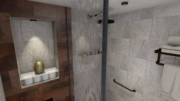 Un baño moderno con cabina de ducha de vidrio, tocador de madera y un perchero.