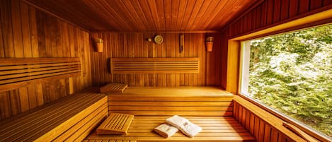 A wooden sauna with benches and a bench with a towel.