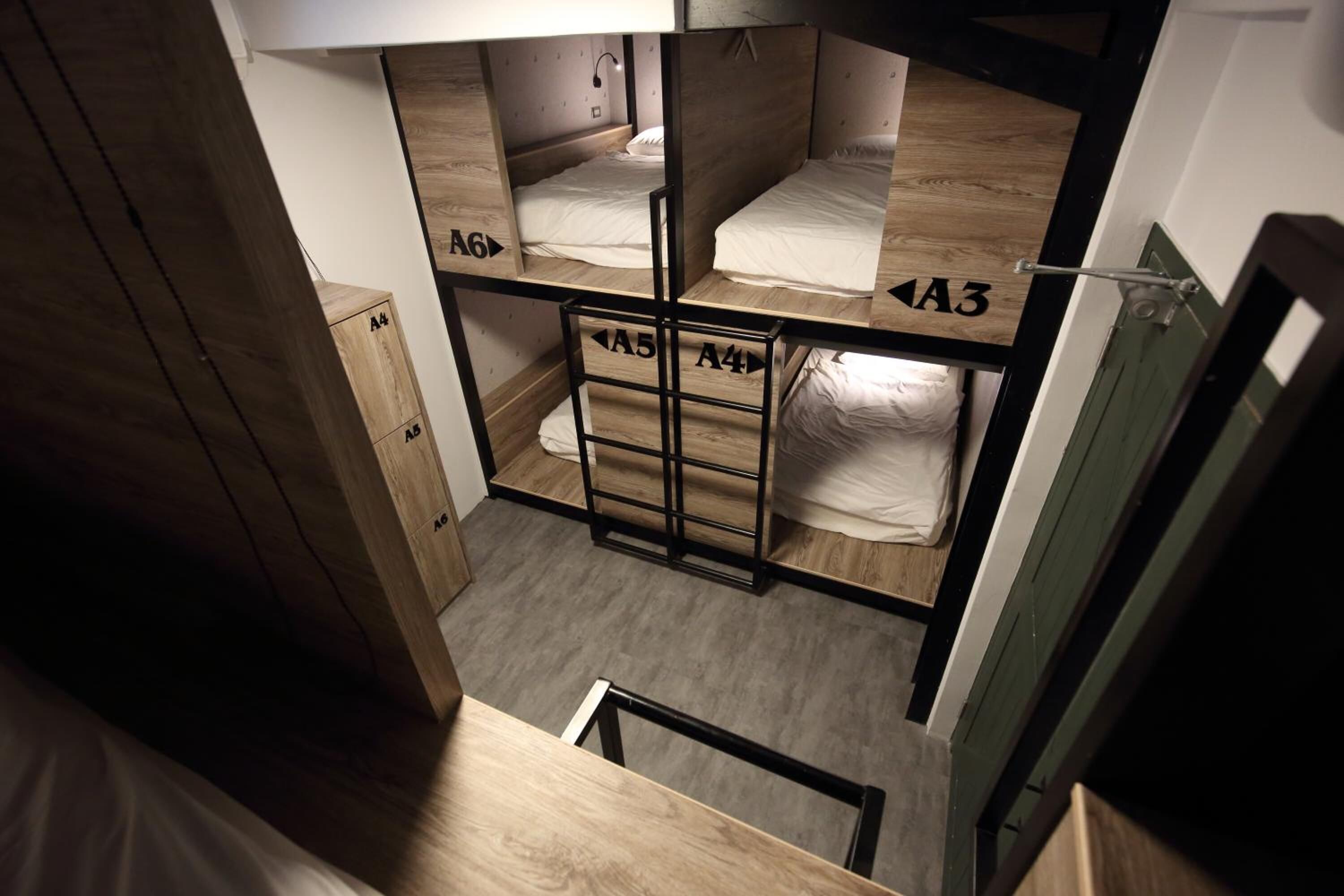 A dormitory-style room with bunk beds labeled A4, A5, and A3.