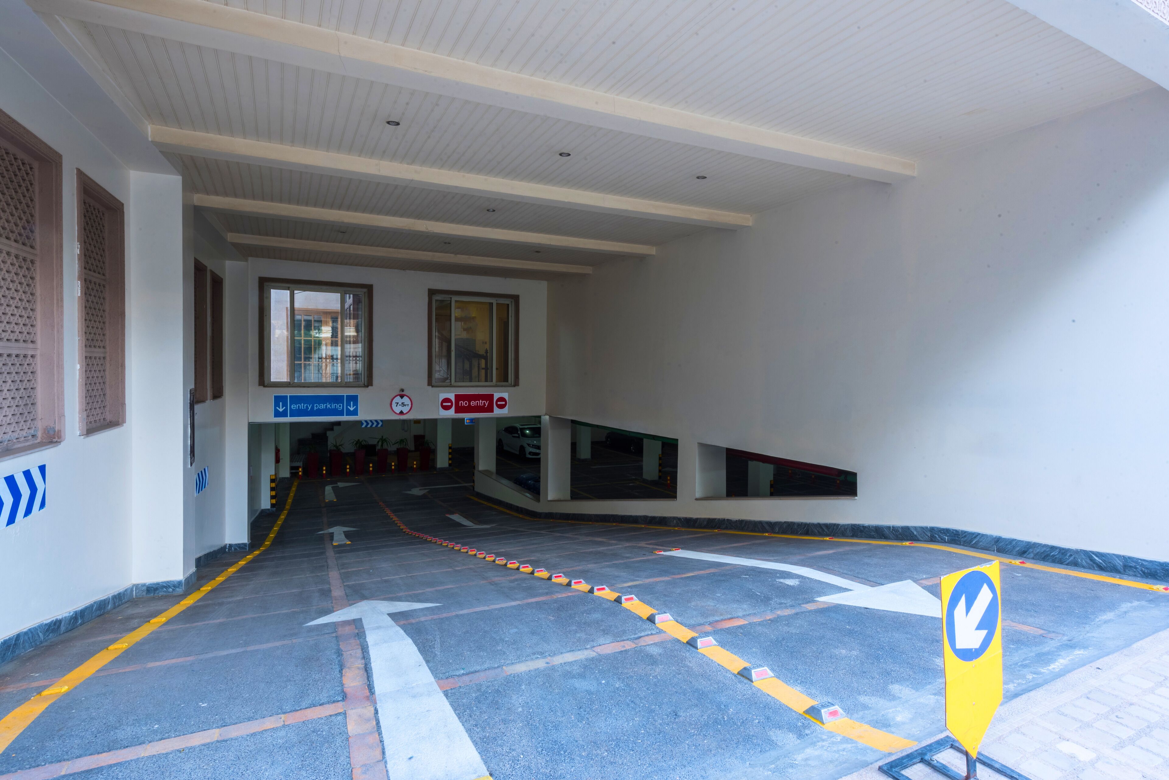 A parking area with directional arrows and a no entry sign.