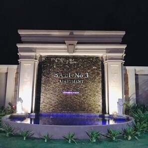 A building facade with the text "BALI No 3 APARTMENT" and a pool area with plants around it. - New CityView Safe Home 5min to Downtown (Phnom Penh)