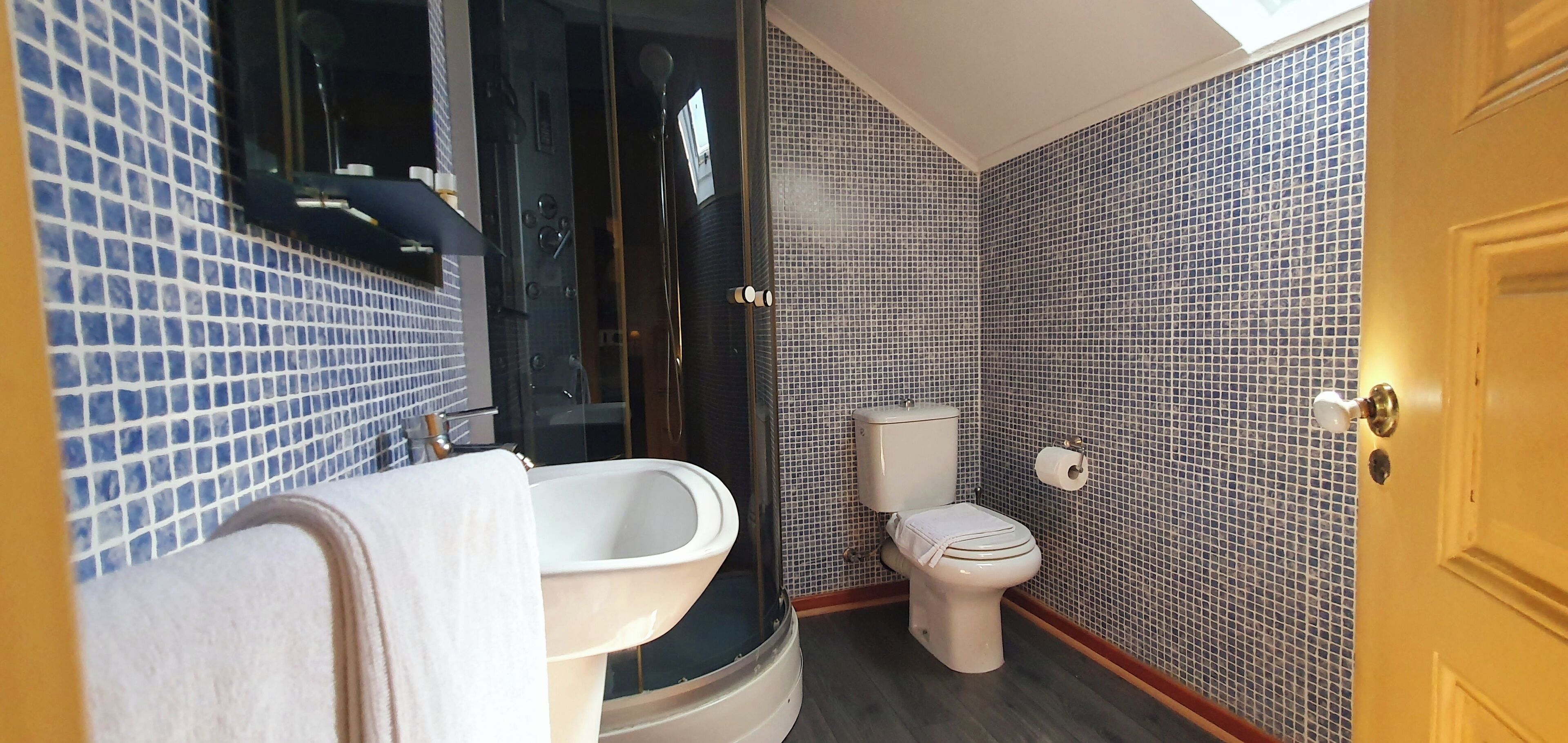 Ein Badezimmer mit Badewanne, Toilette und Duschkabine.