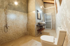 A bathroom with a shower, sink, and toilet.