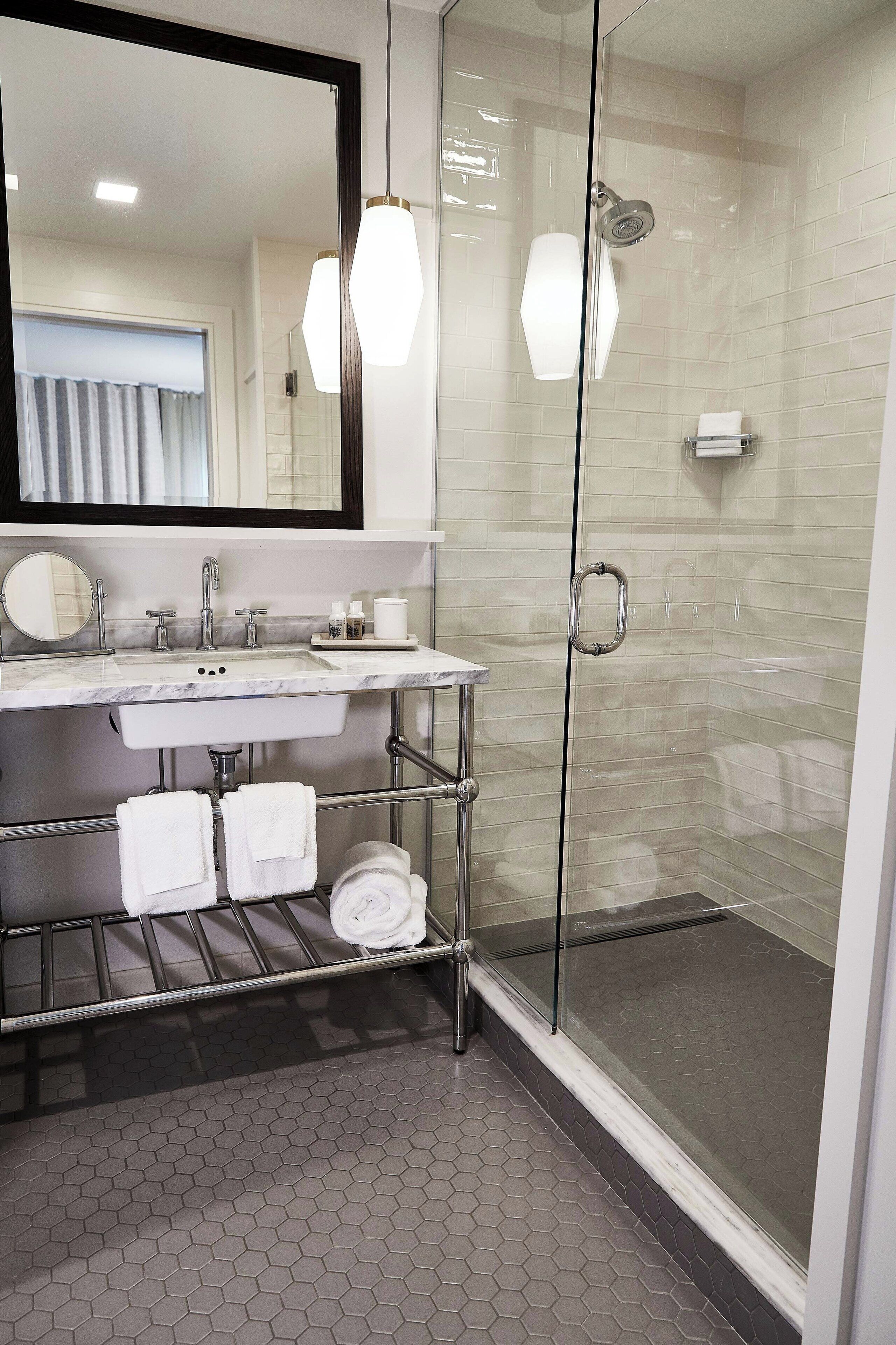 combined shower/bathtub, designer toiletries, hair dryer, bathrobes