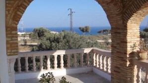 A balcony with a view of the sea and power lines. - Luxury Home With Unique Gulf View Of Hammamet (Hammamet)