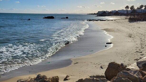 A beach with clear skies, calm water, and rocky outcrops. - Luxury Home With Unique Gulf View Of Hammamet (Hammamet)