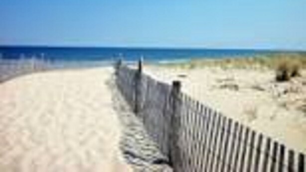 A sandy beach with a wooden fence. - Ocean View and only steps to the sand !! (Fenwick Island)