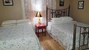 A room with two beds, a nightstand with a lamp, and a window with curtains. - Steve & Katie Riley Guest House, Breaux Bridge, 2 Bd, 1.5 Ba. Welcome!  Sleeps 6 (Breaux Bridge)