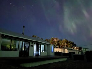 A building with a flat roof, large windows, and a chimney. - Park Beach Retreat - Ideal for couples (Dodges Ferry)