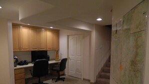 A home office with a desk, computer, and office chair. There is a door and a staircase leading to another room. - Gateway to Zion - Sleeps 8! (Hurricane)