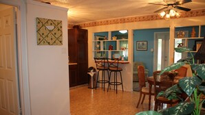 A kitchen with a dining area, a coffee machine, and a window with a view. -  Country  Cottage Home (Bradenton)