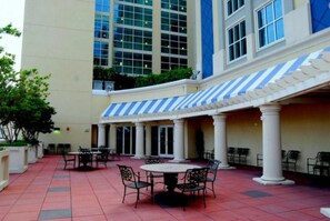 Relax on the patio, surrounded by white columns and comfortable seating.