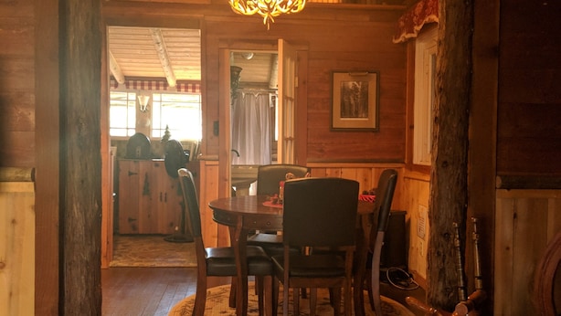A wooden interior with a dining table and chairs, a chandelier, and a wooden floor. -  11 miles to Kings Canyon Natl Park with Wi-Fi (Miramonte)
