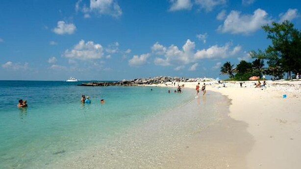 A beach with clear turquoise water, a sandy shore, and a few people swimming. - STEPS TO DUVAL, OLD TOWN!  'LA DOLCE VITA'  #6, SLEEPS 2-4, 3  BLKS TO STH BCH (Key West)