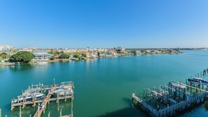 A marina with docked boats and a cityscape in the background. - Harborview Grande, Clearwater Beach - Private Balcony, Walk to It All (Clearwater Beach)