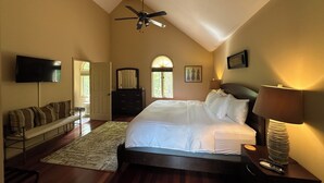 A bedroom with a bed, a ceiling fan, a TV, a dresser, and a window. - Perfect for Large Groups • Hot Tub • Fire Pit • Fast Wi-Fi & Sparkling Clean (Pisgah Forest)