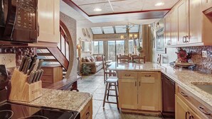 A kitchen with granite countertops, wooden cabinets, and a built-in microwave. - Gorgeous Ski Mountain Views 2 Bedroom, 2 Bath - Ski In Out Condo at Beaver Run (Breckenridge)