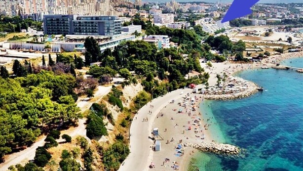 An aerial view of a coastal city with a beach, buildings, and a clear blue sea. - Aquamarine beach apartment- terrace, seaside (Split)