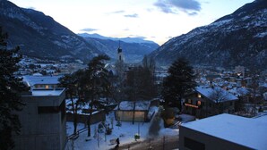 A snow-covered mountain village with buildings and a church.
