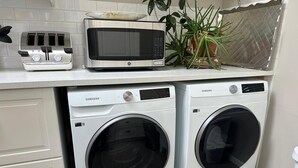A compact kitchen with a microwave, toaster, and washing machines. - Feel at Home , all sanitized, 6 walkable blocks from Santa Fe Plaza. (Santa Fe)
