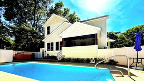 A two-story house with a swimming pool, a covered patio, and a fenced yard. - Escape to the Beech House: A Wooded Family- Friendly Retreat Close to the Beach! (Kitty Hawk)