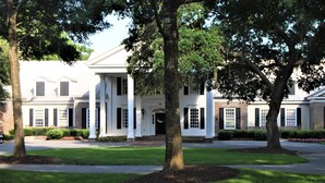 A traditional building with a symmetrical facade, large windows, and a central entrance. - Best of Pawleys Plantation!   Inviting Retreat for Golfers and Beach Lovers (Pawleys Island)