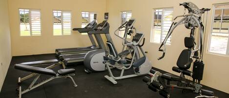 A gym with treadmills, an elliptical, and a weight machine.