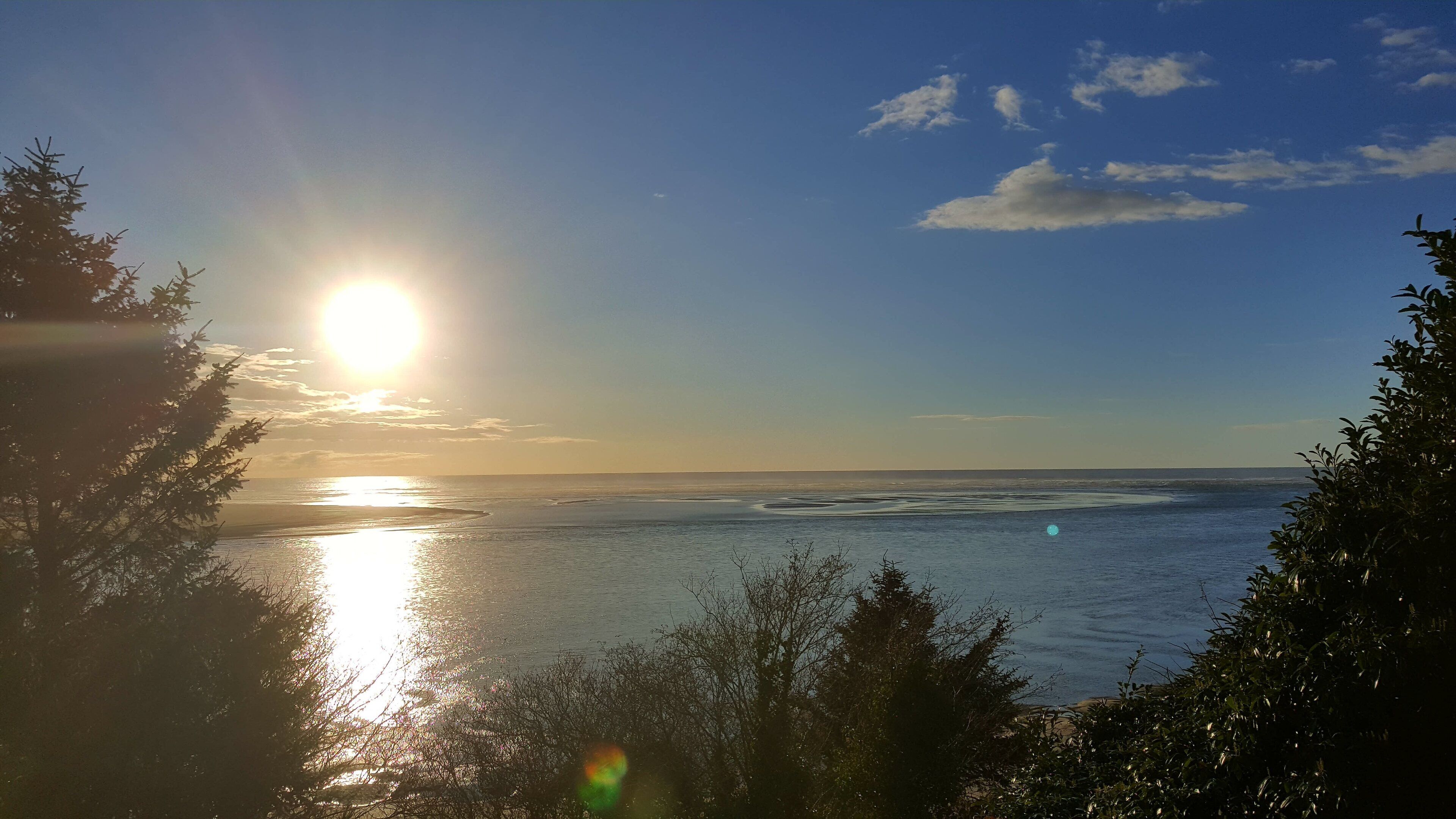 A coastal landscape with a view of the sea and a clear sky.