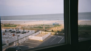 A parking lot with a view of the beach and ocean through a window. - Direct Oceanfront 2 Bedrm, 2 Bath ATLANTIS Coastal Hwy at 103rd St (Ocean City)