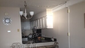 A compact living space with a dining area, kitchen, and seating area. - Direct Oceanfront 2 Bedrm, 2 Bath ATLANTIS Coastal Hwy at 103rd St (Ocean City)