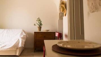 A bedroom with a bed, a dresser, a mirror, and a door.