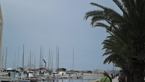 A marina with boats docked along the water's edge.